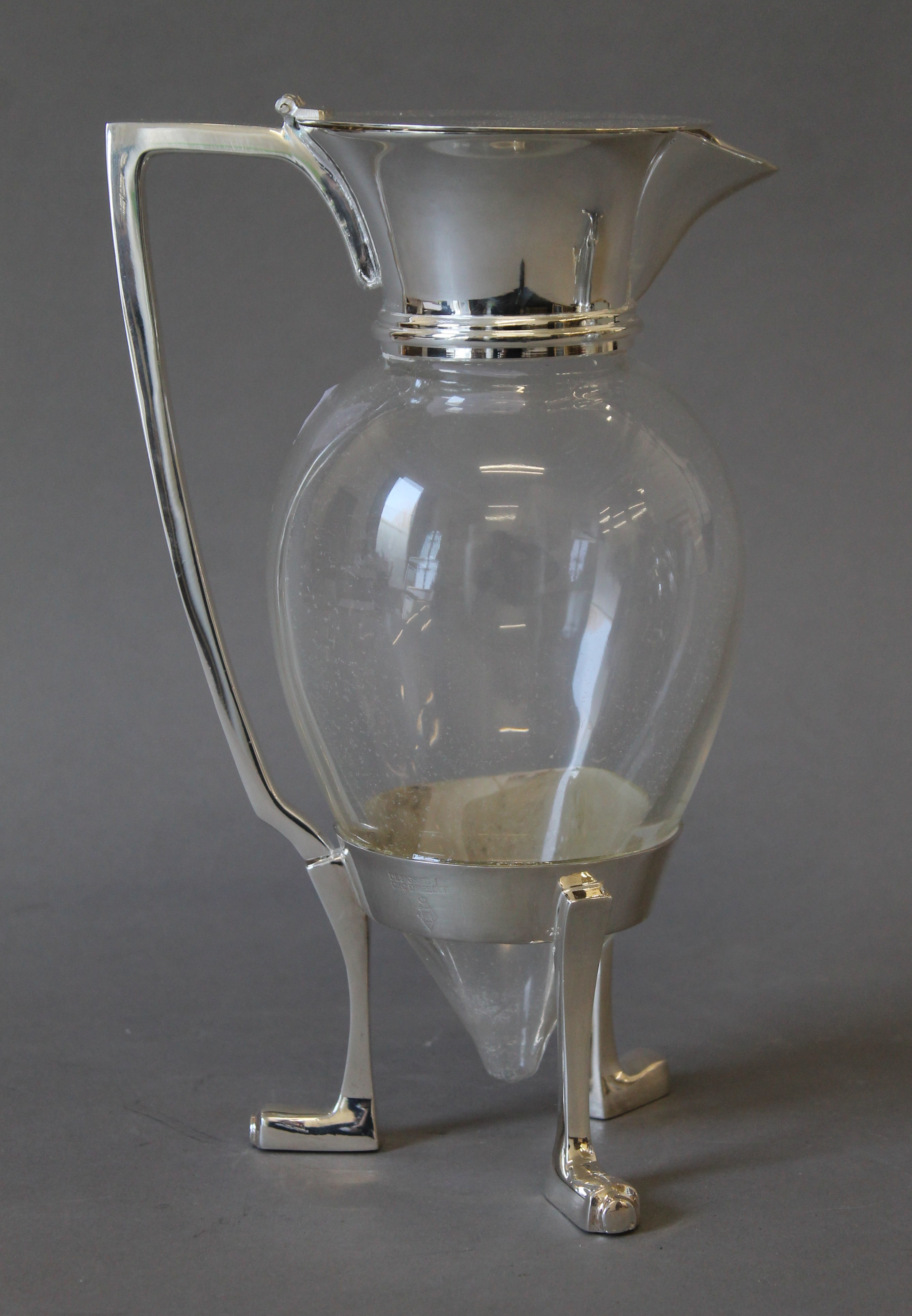 A Christopher Dresser style silver plated crow foot claret jug. 25 cm high.
