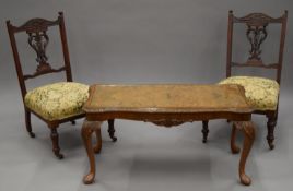 A pair of Victorian nursing chairs and a walnut coffee table.