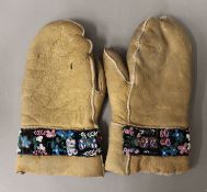 A pair of beadwork decorated mittens. 26 cm long.