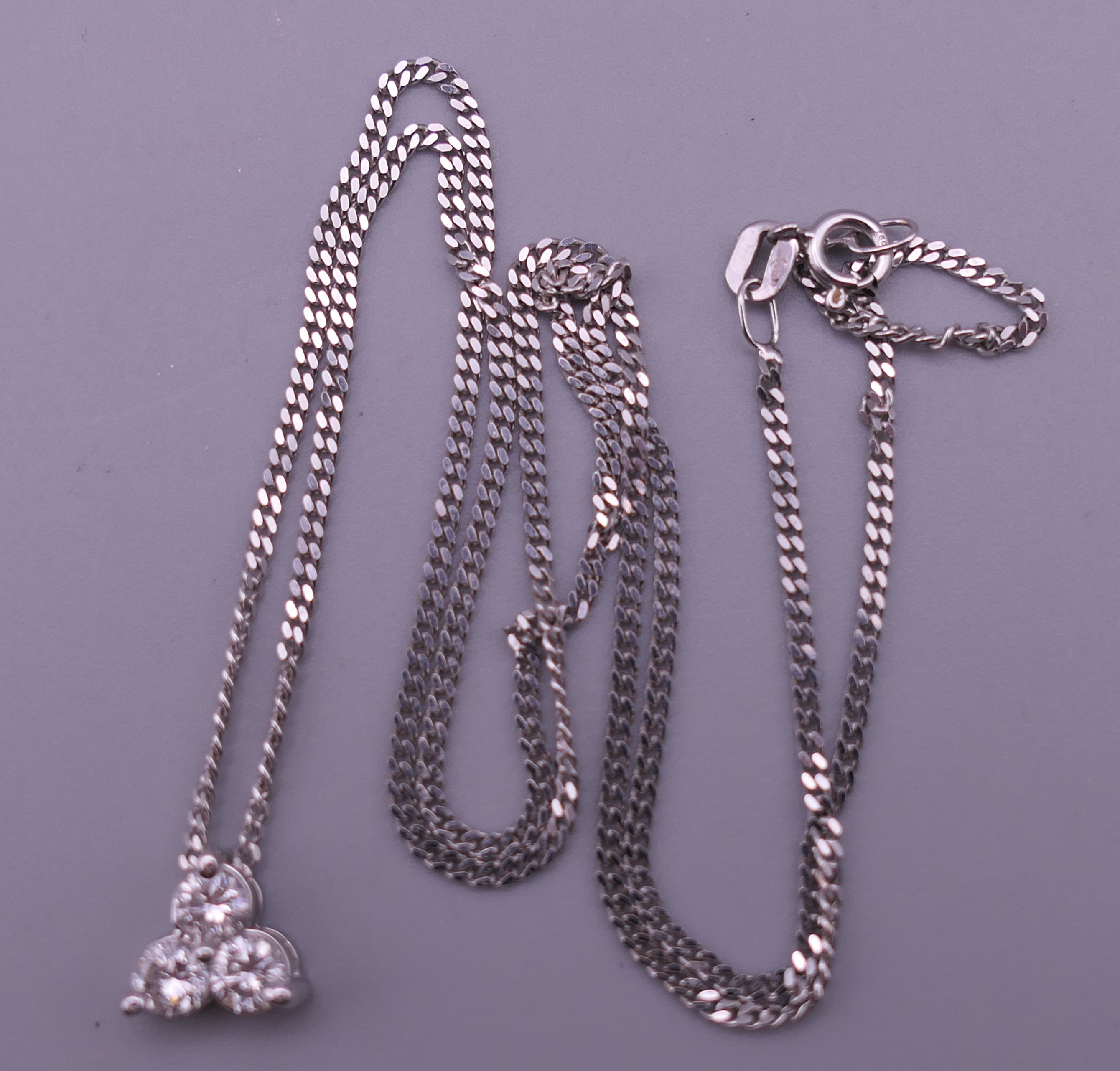 An 18 ct white gold and diamond necklace and pendant and a pair of matching earrings. - Image 5 of 8