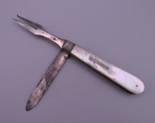 A mother-of-pearl penknife and fork. 8.5 cm long.