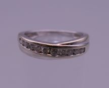 A white gold diamond set half hoop eternity ring. Ring size N.