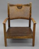 A caned child's chair. 52 cm wide.