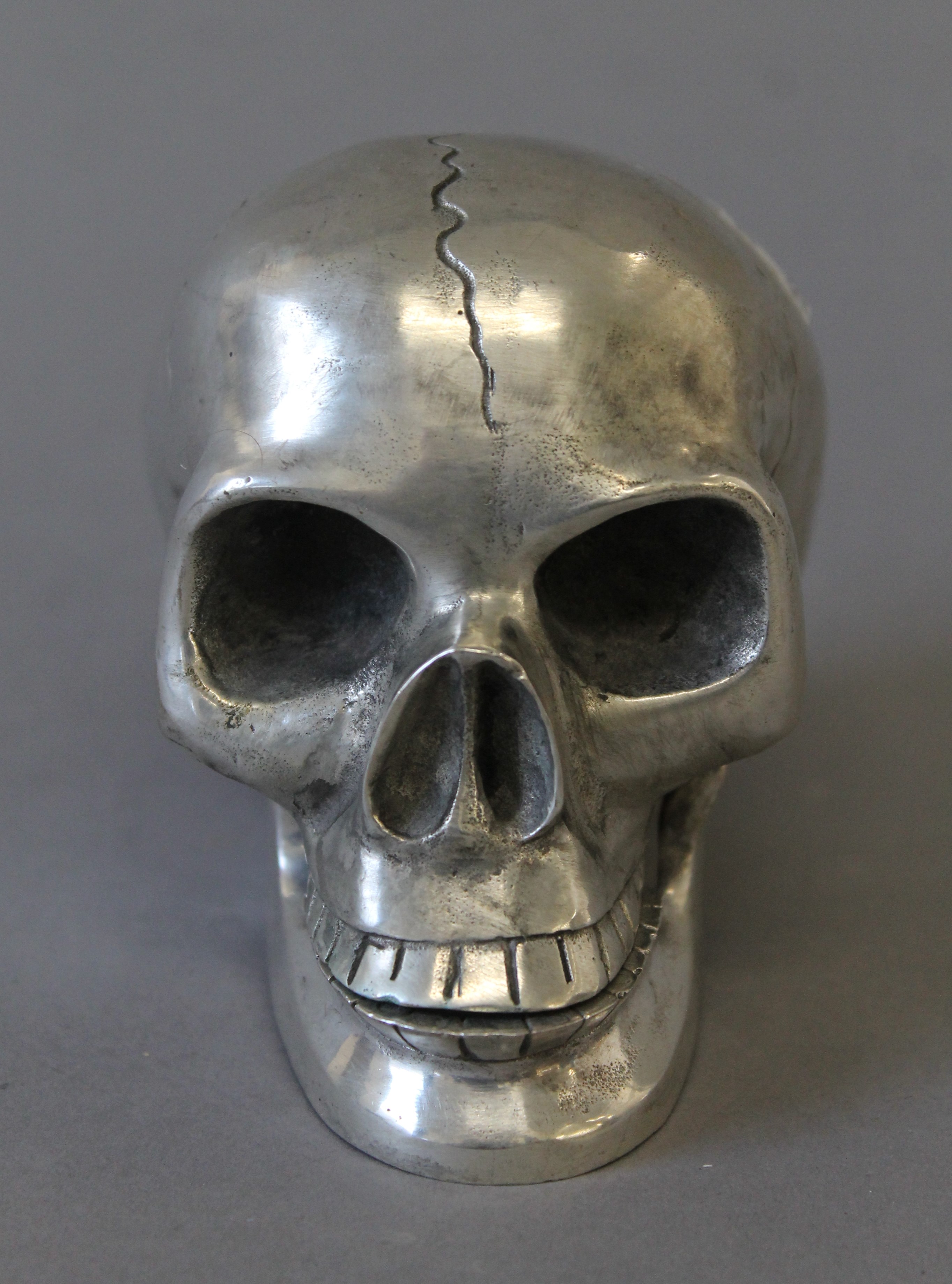 A silvered metal model of a skull. 9.5 cm high. - Image 2 of 3