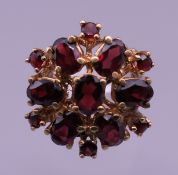 A 9 ct gold garnet ring. Ring size M. 7.1 grammes total weight.