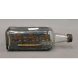 A ship in a bottle. 24 cm long.