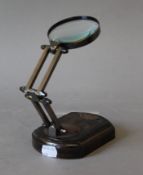 A magnifying glass on stand. 13 cm long.