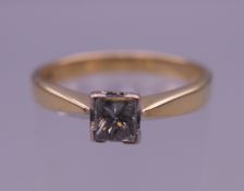 An 18 ct gold princess cut diamond solitaire ring. Diamond approximately 0.34 carat. Ring size N. 3.