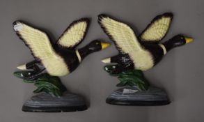 Two cast iron duck form door stops. 25 cm high.