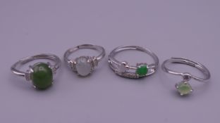 Four silver dress rings.