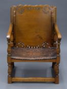 An early 20th century oak and leather monk's chair. 52 cm wide.