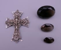 A French cross and three smoky quartz gem stones. Cross 6.5 x 5 cm. Largest gem stones 3.5 x 2.