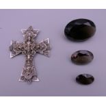 A French cross and three smoky quartz gem stones. Cross 6.5 x 5 cm. Largest gem stones 3.5 x 2.