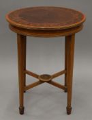 An Edwardian painted and inlaid circular side table. 54 cm diameter.