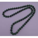 A string of malachite beads. 80 cm long.