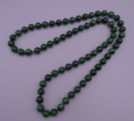 A string of malachite beads. 80 cm long.