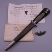 A Fairburn-Sykes Commando fighting knife with scabbard,