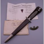 A Fairburn-Sykes Commando fighting knife with scabbard,