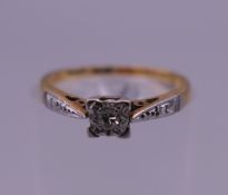 An 18 ct gold and platinum diamond solitaire ring. Ring size I/J. 2 grammes total weight.