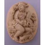 A relief carving, possibly lava, depicting a huntsman and a young woman. 5 cm high.