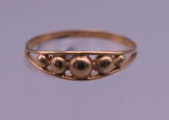 A 9 ct gold five ball ring. 1 gram.