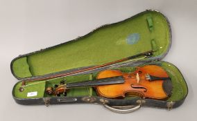 A cased 3/4 size violin and bow. 51 cm long.