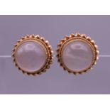 A pair of moonstone ear studs. 1 cm diameter. 3 grammes total weight.