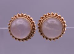 A pair of moonstone ear studs. 1 cm diameter. 3 grammes total weight.