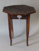 An Eastern carved octagonal side table, the top decorated with birds. 45 cm high.