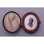 A Georgian Miers and Field heightened portrait silhouette miniature, mounted in a leather case. 4.