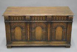 A carved oak coffer. 116 cm wide.