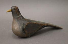 A vintage painted wooden decoy pigeon. 32 cm long, 15 cm high, 8 cm wide.