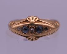 An 18 ct gold diamond and sapphire ring. Ring size M/N. 2.1 grammes total weight.