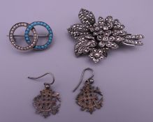 A pair of silver earrings and two silver brooches. Bouquet brooch 5 cm high.