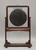 A 20th century bronze gong on brass mounted mahogany stand. 101 cm high.