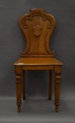 A Victorian oak hall chair. 43 cm wide.