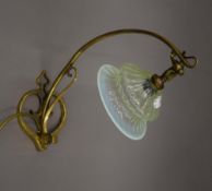 An Art Nouveau brass lamp with uranium glass shade. 37 cm high.