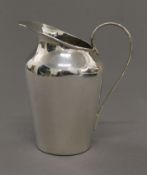 A silver cream jug. 9.5 cm high. 97.3 grammes.