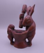 A Japanese wooden model of rabbits grinding a pestle and mortar. 10.5 cm high.