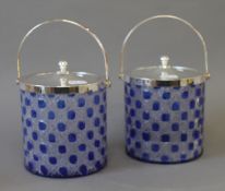 A pair of silver plated and cut glass biscuit barrels. 22 cm high including handle.