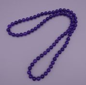 A lavender jade bead necklace. 70 cm long.