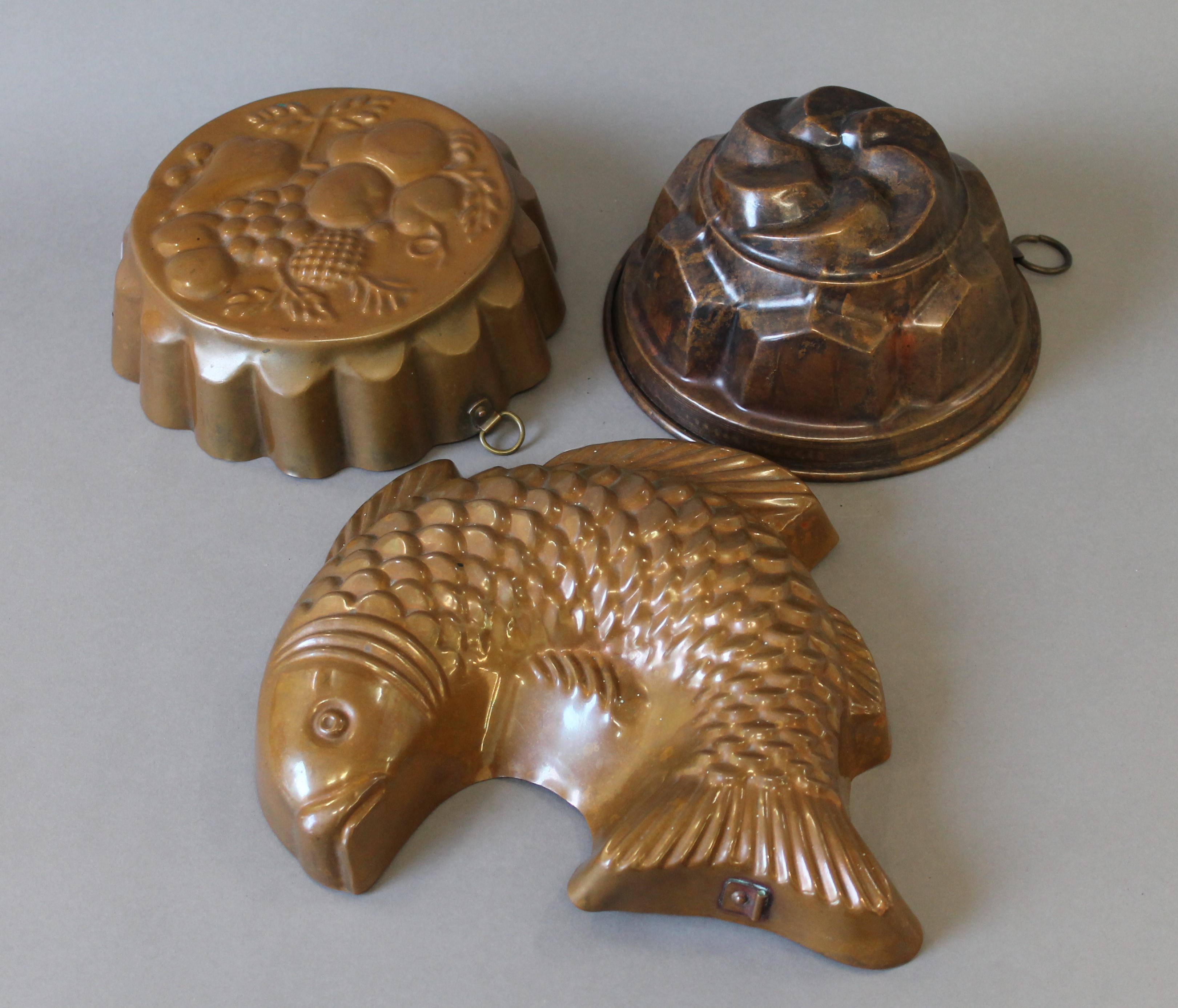 Three copper jelly moulds.