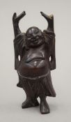 A small 19th century carved wooden model of buddha. 10 cm high.