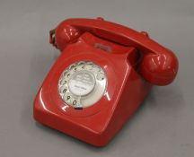 A vintage red telephone.