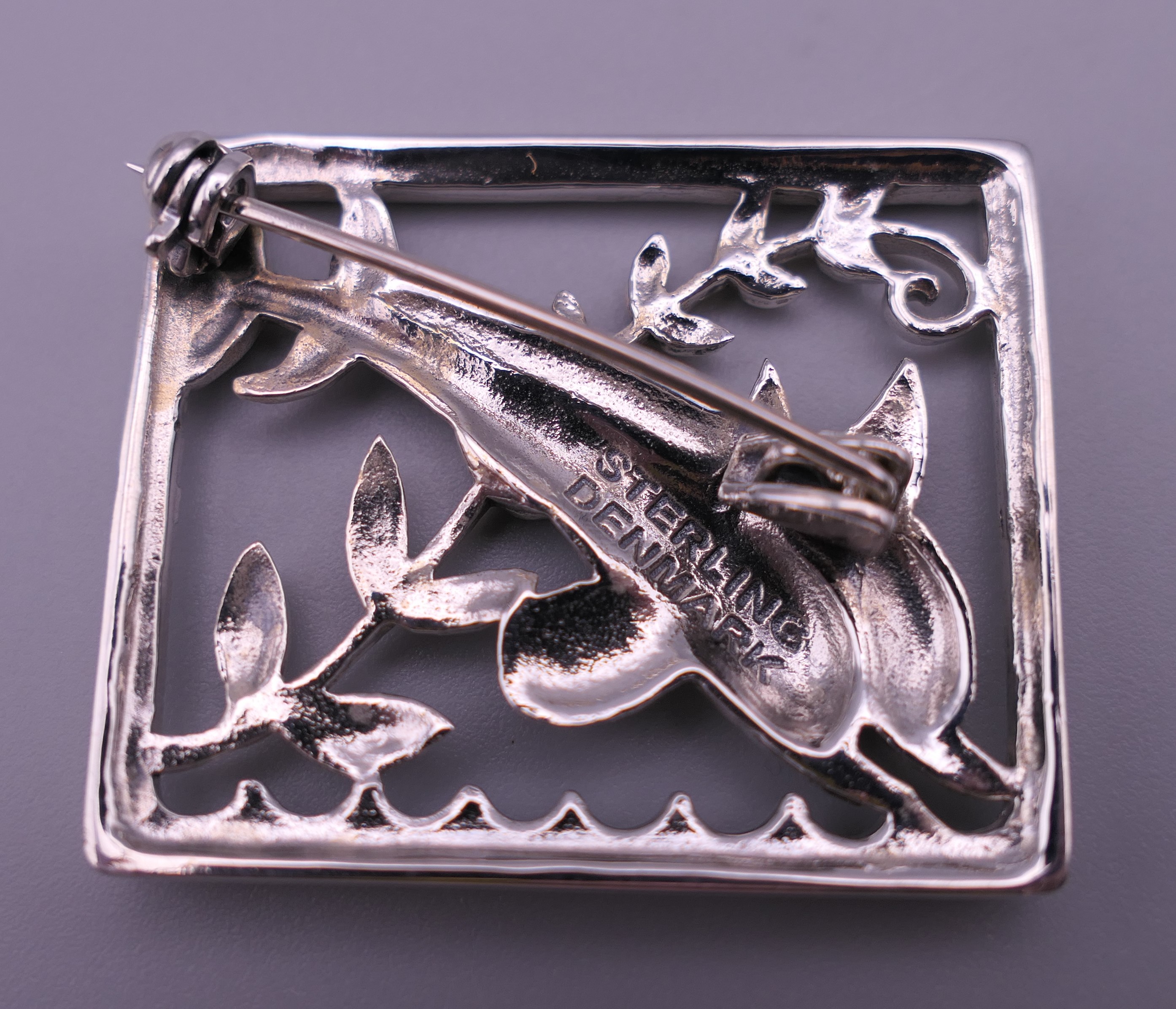 A silver dolphin brooch. 3.5 cm x 2.75 cm. - Image 2 of 4