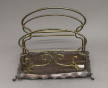 An Arts and Crafts brass and copper magazine rack.