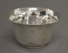A coin set silver bowl. 9.75 cm diameter. 112.9 grammes total weight.