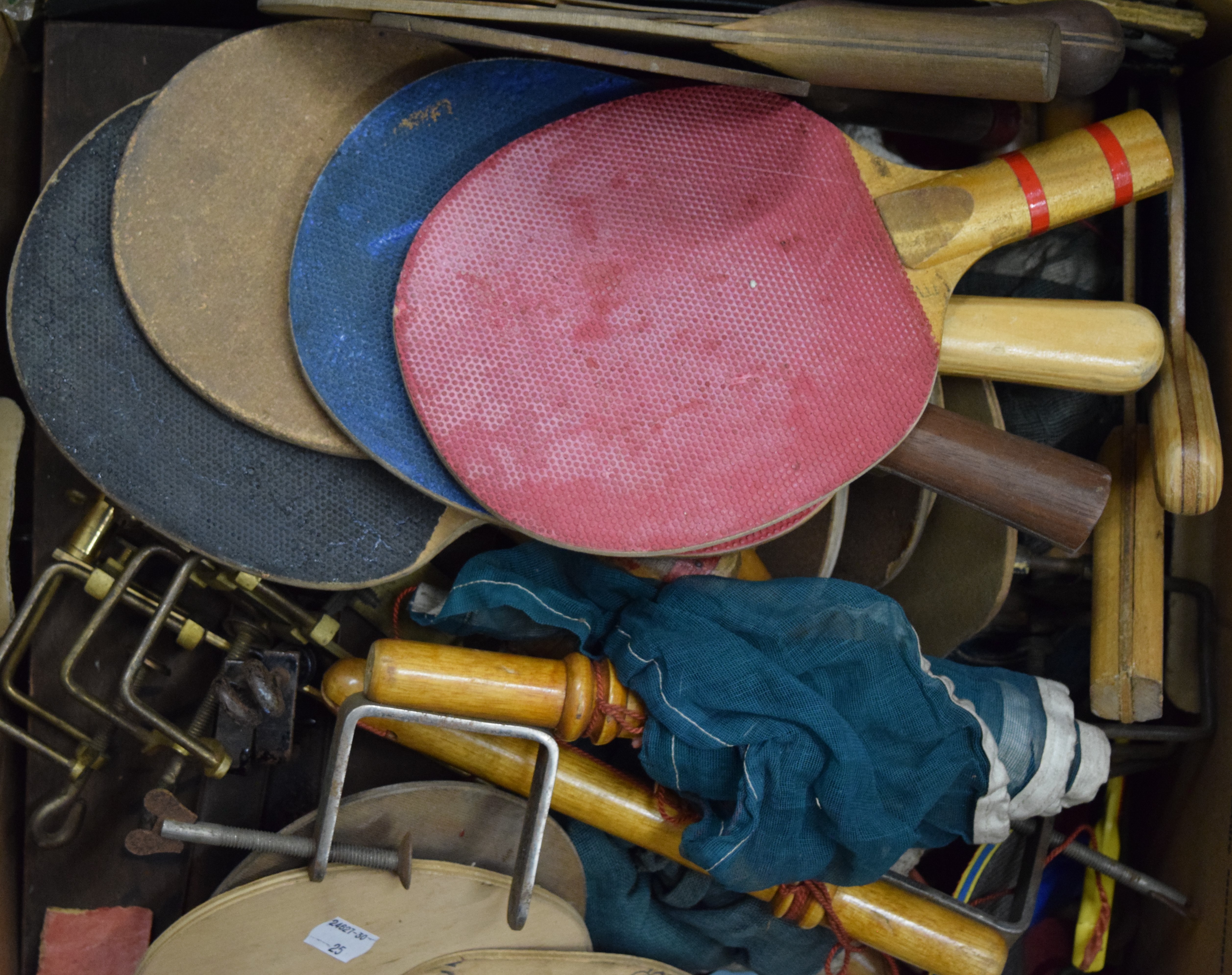 A box of table tennis bats, nets and balls.