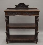 A Victorian carved oak buffet. 105.5 cm wide.