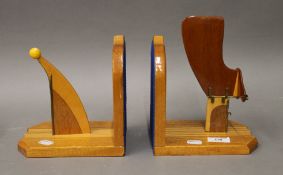 A pair of wooden prow and rudder form bookends. 19 cm high.